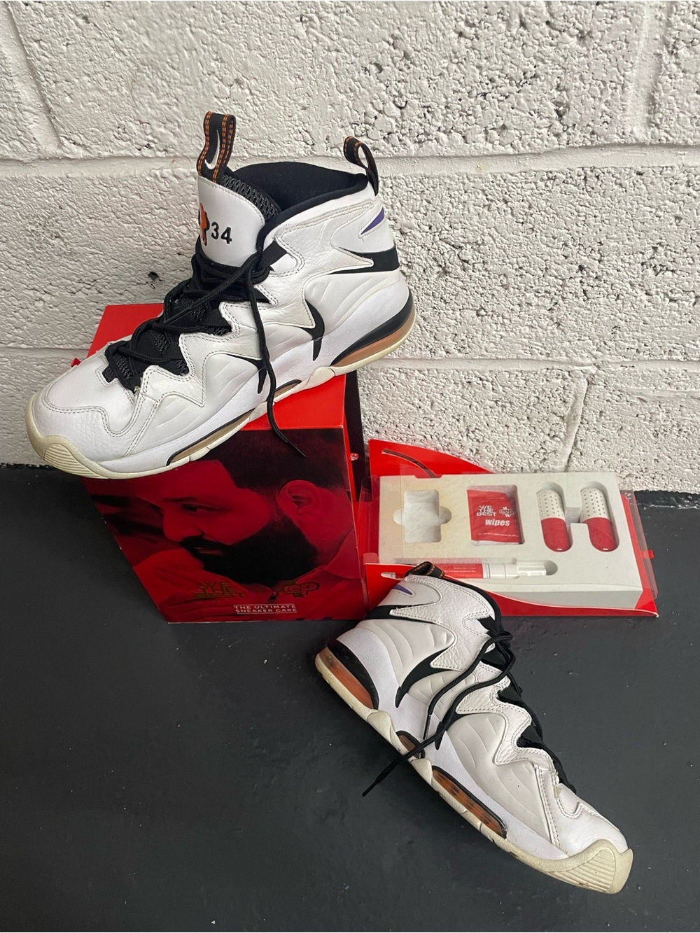 Nike White and Black High-Top Sneakers with Orange Heel Accents